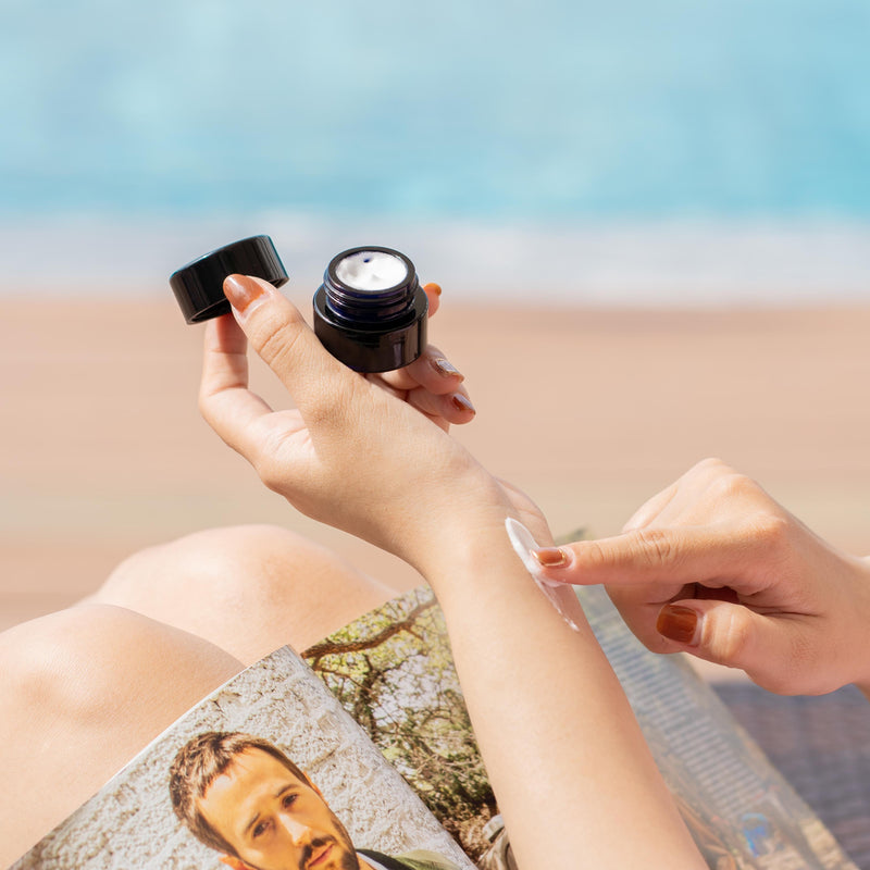 A small black childproof screw top glass jar.