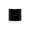 A small black childproof screw top glass jar.