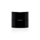 A small black childproof screw top glass jar.